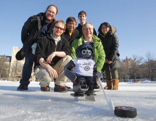 Andrew Winton, Chris Iverach-Brereton, Meng Cheng Lau, Derek Cormier, Prof Jacky Baltes, Wei-Jen Tsai, with the robot hockey player Jennifer at the U of M skating rink. This is the crew that made the robot project.   PLEASE SEE JENNIFER FORD STORY. February 14, 2012  BORIS MINKEVICH / WINNIPEG FREE PRESS
