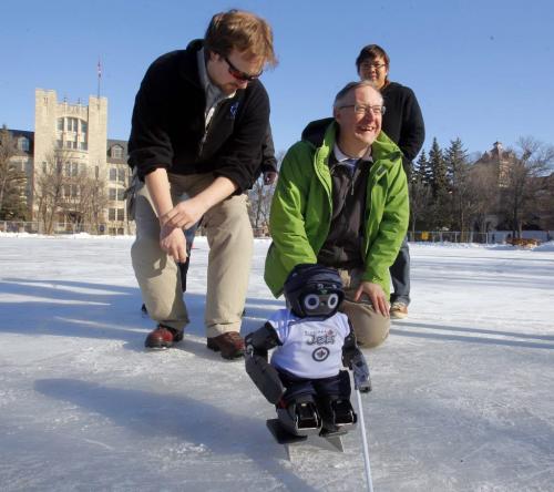 Chris Iverach-Brereton, Meng Cheng Lau, behind, and Prof Jacky Baltes, with the robot hockey player Jennifer at the U of M skating rink. This is the crew that made the robot project.   PLEASE SEE JENNIFER FORD STORY. February 14, 2012  BORIS MINKEVICH / WINNIPEG FREE PRESS