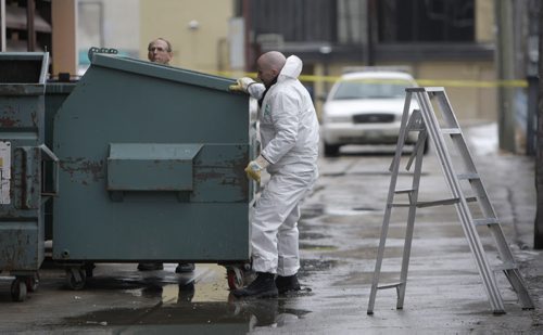Winnipeg Police search through a large garbage bin in the area of York Avenue near Donald Street, February 20, 2012. Police are investigating what they call "suspicious circumstances." (TREVOR HAGAN/WINNIPEG FREE PRESS) Winnipeg's 5th homicide of 2012.