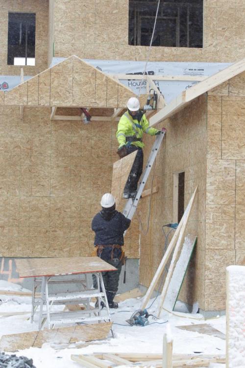 House builders frame up a house in Sage Creek. They agreed to be photographed but prefered to not have their names used.  February 21, 2012  BORIS MINKEVICH / WINNIPEG FREE PRESS