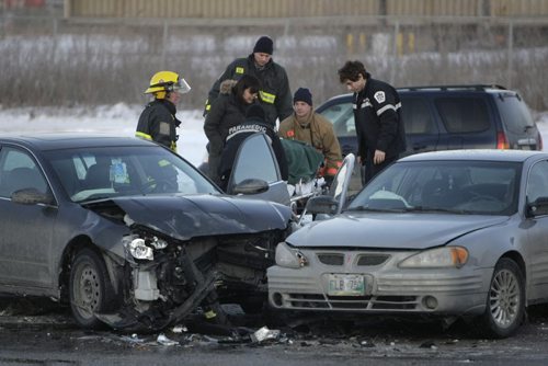 Paramedics transport one person involved in a car accident on the 600 block of southbound Keewatin, near the underpass, Friday February 24, 2012. (TREVOR HAGAN/WINNIPEG FREE PRESS)