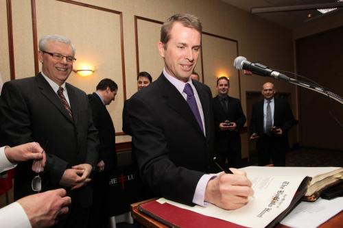 Jeff Stoughton signs the registry of the Order of the Buffalo Hunt after his team was inducted by Primier Selinger into the Order of the Buffalo Hunt while at the Lung Association of Manitoba galla dinner at the Victoria Inn. 120225 Mike Deal / Winnipeg Free Press