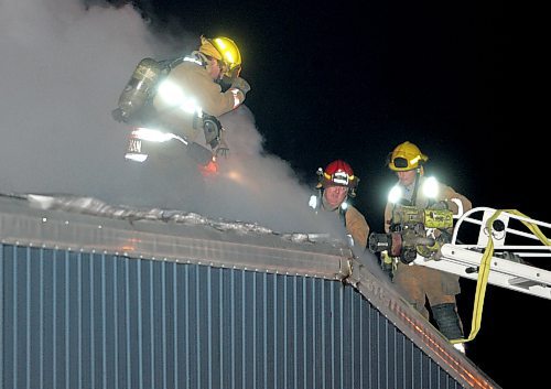 BORIS MINKEVICH / WINNIPEG FREE PRESS  070124 Fire fighters on top of the roof of a cardboard company on Lowson Cres.