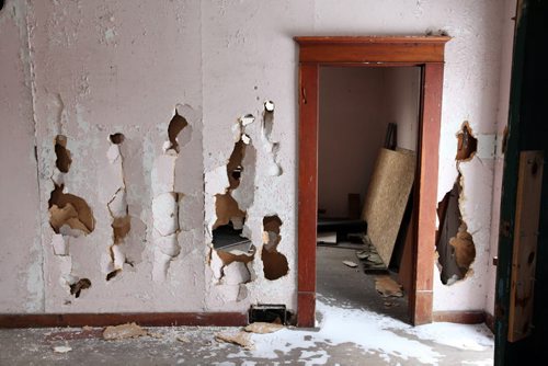 Brandon Sun 25022012 Smashed walls are visible in one of the homes at the Criddle-Vane Homestead south of CFB Shilo on Sunday after vandals caused damage to the provincial heritage park. (Tim Smith/Brandon Sun)