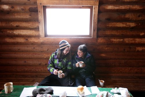 Brandon Sun 25022012 Bryanna Manns and Vanessa Angulo enjoy hot chocolate in the warm-up hut at the Spruce Woods Winter Recreation Area during Family Fun Day, hosted by the Friends of Spruce Woods at the provincial park. The afternoon activities included skating, sledding, a scavenger hunt and chili, hot chocolate and cookies served in the warm up shack. The Manns family is hosting Angula who is a student from Colombia, as well as a student from Mexico. (Tim Smith/Brandon Sun)