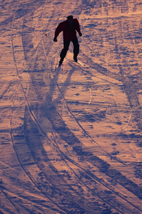 February 28, 2012 - 120228  -  As the colour from the setting sun reflects is the ice and snow a lone skier makes his way down the Assiniboine River at the west Perimeter Tuesday February 28, 2012.    John Woods / Winnipeg Free Press