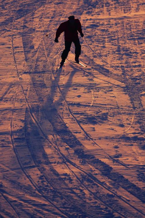 February 28, 2012 - 120228  -  As the colour from the setting sun reflects is the ice and snow a lone skier makes his way down the Assiniboine River at the west Perimeter Tuesday February 28, 2012.    John Woods / Winnipeg Free Press