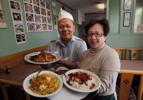 Restaurant Review.. Evergreen Restaurant on Pembina Hwy. co-owners Teresa Lau with curry vermicelli and barbecue pork with rice and her husband Loy Lau with a plate of barbecue duck. Marion Warhaft story   (WAYNE GLOWACKI/WINNIPEG FREE PRESS) Winnipeg Free Press Jan. Feb 29 2012