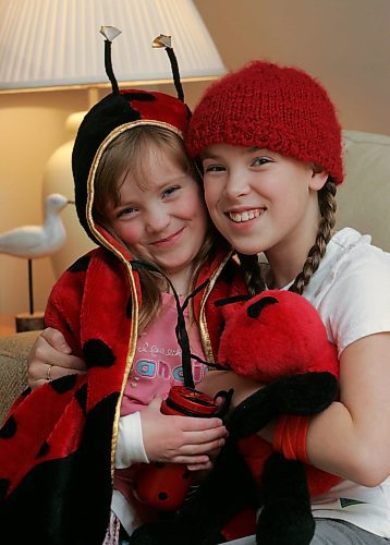 BORIS MINKEVICH / WINNIPEG FREE PRESS  070125 Hannah Taylor and her little sister Gabriella,5, pose for a portrait in her home.