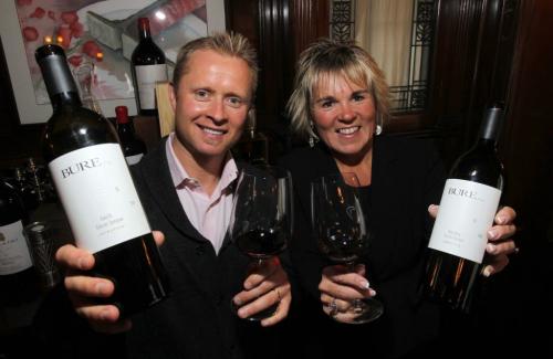 Valeri Bure, former sniper with the Calgary Flames and Florida Panthers, is in town doing some promotional work with his wine company, Bure Family Wines in California and Banville & Jones Tina Jones pose for a photo at 529 Wellington restaurant with some of his wine.  March 2, 2012  BORIS MINKEVICH / WINNIPEG FREE PRESS