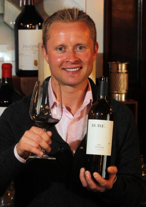 Valeri Bure, former sniper with the Calgary Flames and Florida Panthers, is in town doing some promotional work with his wine company, Bure Family Wines in California poses for a photo at 529 Wellington restaurant with some of his wine.  March 2, 2012  BORIS MINKEVICH / WINNIPEG FREE PRESS