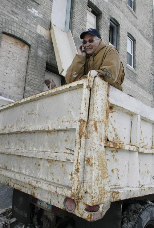 John Woods / Winnipeg Free Press / January 26/07 - 070126  - Don Jones of Harpeen Construction poses for a photo in the back of his dump truck which he has affectionately called Big Bertha Friday, Jan 26/07.   Jones has used his truck to take unwanted clothes from a downtown warehouse to the dump.