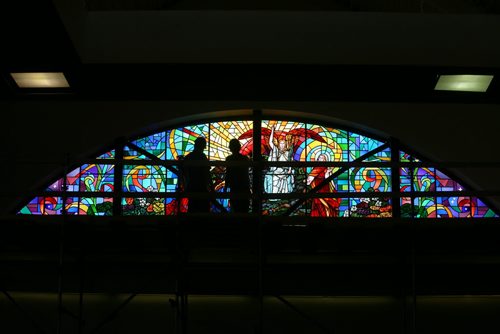 Brandon Sun Spyros Peter Doulias of Robert McCasuland Lts., of Toronto, works with his assistant to install the final sections of stained glassin the west ceiling window of Central United Church on Wednesday. The scene of the Resurrection, depicted in the multi-section window, took two days to install but more than six months to create. (Bruce Bumstead/Brandon Sun) (Bruce Bumstead/Brandon Sun)