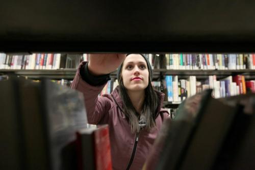 Carly Moore browses through books at the Winnipeg Millenium Library Thursday evening.  Photo is for story on no library fees. March 08 2012 (Ruth Bonneville / Winnipeg Free Press)