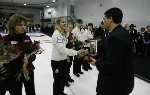 John Woods / Winnipeg Free Press / January 29/07 - 070129  - Jennifer Jones receives the trophy after winning the Scotties Tournament of Hearts in Morris Sunday, Jan 28/07.   Her opponent Darcy Robertson stands dejected after losing 9-6.