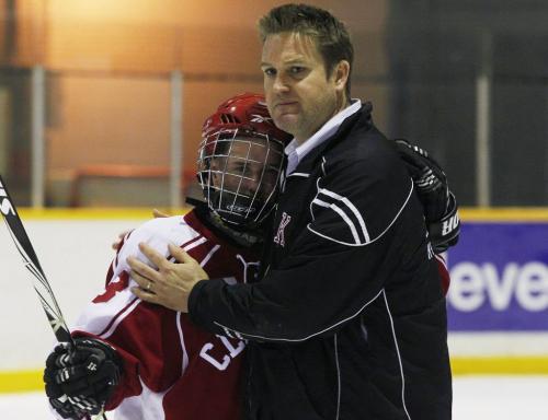 March 12, 2012 - 120312  -  A coach embraces Kelvin Clippers Torin Wiwchar (8) after they lost to the St Paul's Crusaders in the 2012 Provincial AAAA Boys' High School Hockey Championship Monday March 6, 2012. John Woods / Winnipeg Free Press