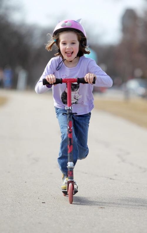 Six year old Petra Steadwell zooms along on her scooter Saturday afternoon while spending time at Assiniboine park with her family. March 27 2012 (Ruth Bonneville/Winnipeg Free Press)