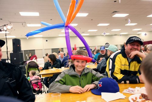 Brandon Sun 26032012 Chase Fardoe of Brandon sports a colourful balloon hat during the Royal Manitoba Winter Fair's traditional Western Breakfast at the Keystone Centre's Convention Hall on Monday morning. The breakfast officially kicked off the fair which runs until March 31. (Tim Smith/Brandon Sun)
