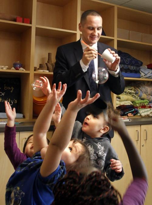 Children and Youth Opportunities Minister Kevin Chief blows bubbles for children after the official opening Monday of the Lord Selkirk Park Early Learning and Child Care Centre. It is the launch of a first-in-Canada early learning model.  Melissa Martin  story.   (WAYNE GLOWACKI/WINNIPEG FREE PRESS)  Winnipeg Free Press  March 26 2012