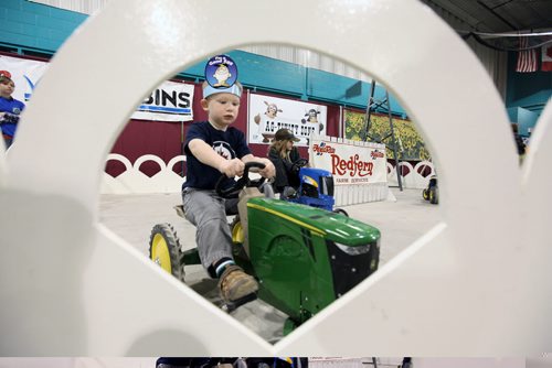 Brandon Sun 26032012 Landon Hofer of Winnipeg drives a tractor trike in the Royal Farm Yard's Ag-tivity Zone during the first day of the 2012 Royal Manitoba Winter Fair at the Keystone Centre. (Tim Smith/Brandon Sun)