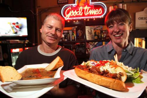 RESTAURANT REVIEW - Yellow Dog bar manager Greg Ash and owner Michelle Chabot pose for a photo with Beef and guiness stew and pulled pork sandwich. March 28, 2012  BORIS MINKEVICH / WINNIPEG FREE PRESS