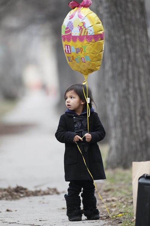April 2, 2012 - 120402  -  A young girl with an Easter balloon joined family and friends as they gathered in front of 238 Balmoral Monday at a vigil for Johnathen Felix Monday April 2, 2012.  Felix was shot outside the residence Sunday April 1, 2012 John Woods / Winnipeg Free Press