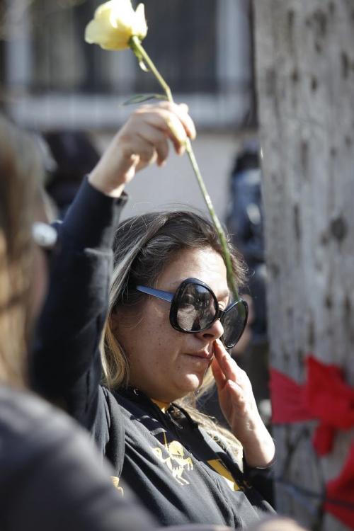 April 3, 2012 - 120403  - A woman wipes away a tear as she places a flower at a vigil Tuesday April 3, 2012 for Carolyn Marie Sinclair and her unborn baby who were found murdered and dumped in a backlane on the 700 block of Notre Dame Avenue Saturday March 31, 2012.  John Woods / Winnipeg Free Press