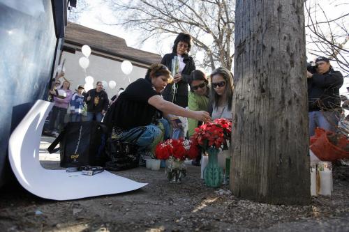 April 3, 2012 - 120403  - Family members place flowers at a vigil Tuesday April 3, 2012 for Carolyn Marie Sinclair and her unborn baby who were found murdered and dumped in a backlane on the 700 block of Notre Dame Avenue Saturday March 31, 2012.  John Woods / Winnipeg Free Press