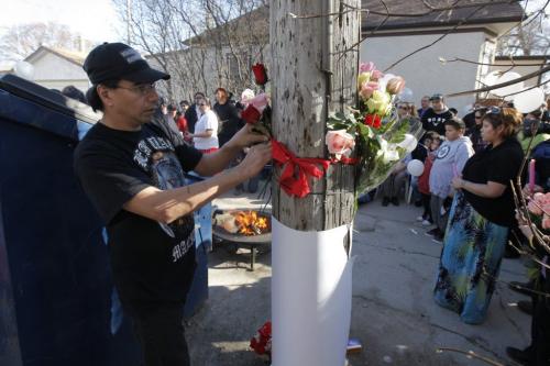April 3, 2012 - 120403  - A man places a flower at a vigil Tuesday April 3, 2012 for Carolyn Marie Sinclair and her unborn baby who were found murdered and dumped in a backlane on the 700 block of Notre Dame Avenue Saturday March 31, 2012.  John Woods / Winnipeg Free Press