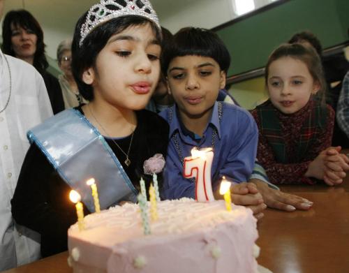 John Woods / Winnipeg Free Press / February  3 2007 - 070203  - Farva Raza (7) blows out the candles on her seventh birthday cake as her brother Zain (8) and friend Ivy Desbiolles (7) look on in the Cresent-Fort Rouge United Church Saturday  Feb 3/07.  The Razas have been taking sanctuary in the church for six months.