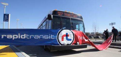 A rapid transit bus drives through a banner to officially launch the Southwest Transitway.  120405 April 05, 2012 Mike Deal / Winnipeg Free Press