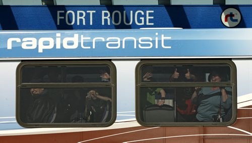 Rapid Transit riders wave as they arrive at the Fort Rouge Station on the opening day of the Southwest Transitway. 120405 - Thursday, April 05, 2012 -  (MIKE DEAL / WINNIPEG FREE PRESS)
deal2012poy