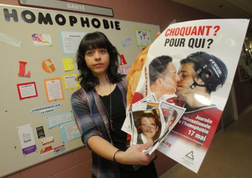 Renee LeNeveu poses for a photo at the posting board where of vandalism of anti-homophobia posters on campus Université de Saint-Boniface. April 6, 2012  BORIS MINKEVICH / WINNIPEG FREE PRESS