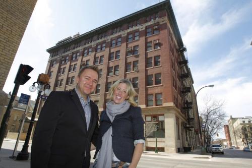 Mark Buleziuk (left) and Shelley Buleziuk pose for a photo with 66 King Street in behind them, a building they are going to develop into commercial. April 6, 2012  BORIS MINKEVICH / WINNIPEG FREE PRESS