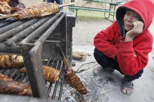 April 8, 2012 - 120408  -  Naw Ki, who immigrated from Thailand three years ago as a refugee, smokes fish over a fire at Kildonan Park Sunday April 8, 2012.    John Woods / Winnipeg Free Press