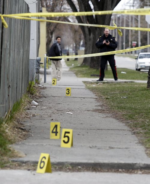 Winnipeg Police at the crime scene on a sidewalk along Andrews Street near a house in the 500 block of Aberdeen Ave. where an injured male was taken to the hospital Monday morning.   (WAYNE GLOWACKI/WINNIPEG FREE PRESS) Winnipeg Free Press  April 9 2012