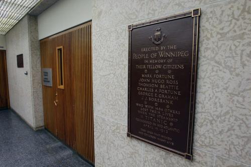Titanic plaque in City Hall honouring six Winnipeg men who died in the disaster.  The plaque is trapped in time in the basement of the Council Building at 510 Main Street and is mounted on the east wall of the building, just at the base of the stairs to the main floor beside the entrance to the Printing Department.    There are 3 streets supposedly named after 3 Winnipeg Titanic victims, all of whom are identified on the plaque:  Fortune Street (after Charles Fortune), Borebank Street (after James Borebank) and Hugo Street  (after John Hugo Ross).   April 9, 2012  BORIS MINKEVICH / WINNIPEG FREE PRESS