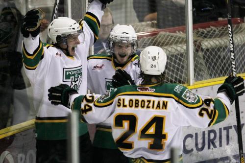 April 10, 2012 - 120410  -  Portage Terriers Brendan Harms (18)(L) celebrates with Brent Wold (16) and Justin Slobozian (24) after scoring the winning goal against the Winnipeg Saints in the MJHL championship 4 games to 1 in Portage La Prairie Tuesday April 10, 2012.    John Woods / Winnipeg Free Press