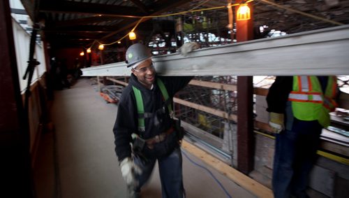 A scaffolder moves an aluminum beam through the interior space of the Canadian Museum for Human Rights for set up Friday. See Dan Lett story. April 13, 2012 - (Phil Hossack / Winnipeg Free Press) CMHR