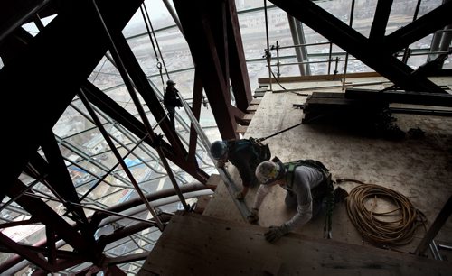 Scaffolders rig a suspended lattice of support scaffolding high in the interior space of the Canadian Museum for Human Rights Friday. See Dan Lett story. April 13, 2012 - (Phil Hossack / Winnipeg Free Press) CMHR