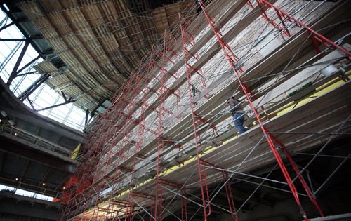 A mason working on an inside wall is dwarfed in the interior space of the Canadian Museum for Human Rights Friday. See Dan Lett story. April 13, 2012 - (Phil Hossack / Winnipeg Free Press) CMHR