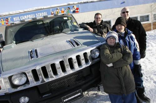 John Woods / Winnipeg Free Press / Februaru 5/07 - 070205  - Neil Campbell School principle John Muller (back) drove Madison Stengel (middle), his friend Ryan Reimer (front), and Madison's dad Jeff around in a Hummer H2 all day Feb 5/07.  Stengel won a playground fundraising draw at the school which included shopping, lunch and a drive in the Hummer.