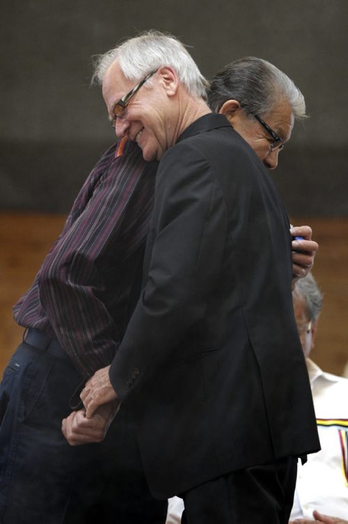 James Weisgerber, the Archbishop of Winnipeg, hugs Tobasonakwut Kinew during the adoption ceremony at Thunderbird House. Anishinaabe elders and community leaders Tobasonakwut Kinew, Fred Kelly, Phil Fontaine and Bert Fontaine adopted James in a traditional "Naabagoondiwin" adoption ceremony at the Thunderbird House. See Nick Martin story 120414 - Saturday, April 14, 2012 -  (MIKE DEAL / WINNIPEG FREE PRESS)