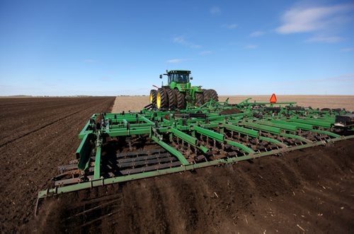 Brandon Sun 16042012 A worker with Keller Farms tills a field southwest of Shilo, Manitoba on a sunny Monday, April 16 afternoon. (Tim Smith/Brandon Sun)