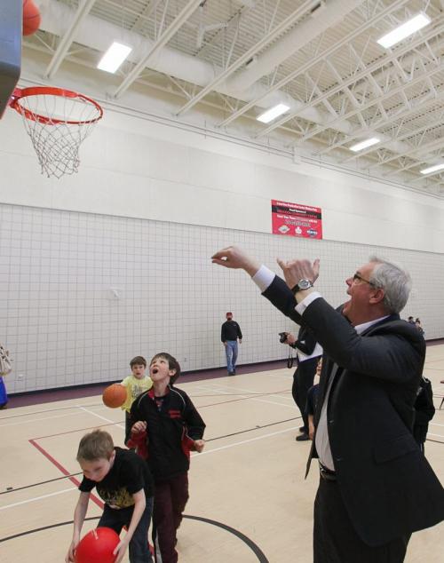 Premiere Greg Selinger tosses fora  basket while playing ball with kids in the newly renovated Winakwa Community Centre on Friday.  120420 - Friday, April 20, 2012 -  Melissa Tait / Winnipeg Free Press