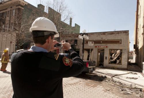 A fire fighter snaps a photo of the remains of the building at 44 Albert Street in the Exchange District, which was destroyed by fire Thursday.  120419 - Thursday, April 19, 2012 -  Melissa Tait / Winnipeg Free Press