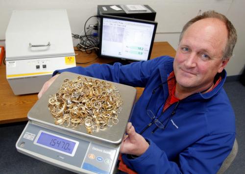 MONEY MATTERS - KMG Gold - Michael Gupton with scrap gold in his business. Behind him is a special xray machine, a Fischerscope X-Ray Flourescence Assay Machine, that is used to scientifically find out how much gold in in scrap.  April 26, 2012  BORIS MINKEVICH / WINNIPEG FREE PRESS