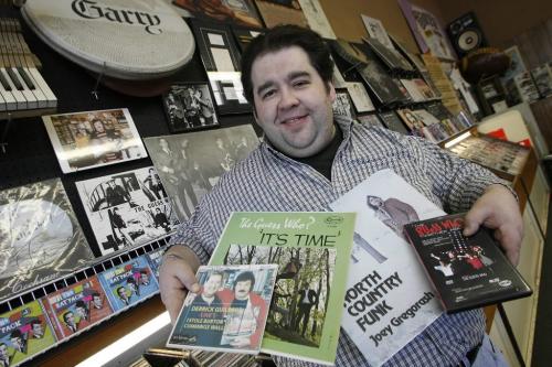 John Woods / Winnipeg Free Press / February  5 2007 - 070205  - Jefferson Bishop, owner of The Sound Exchange on Portage Avenue, poses in the store with some memorabilia Monday February 5/07.