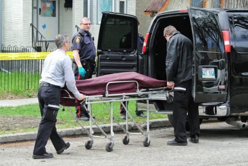 The coroner removes a deceased person from 854 Home Street Tuesday afternoon.  120501 May 01, 2012 Mike Deal / Winnipeg Free Press