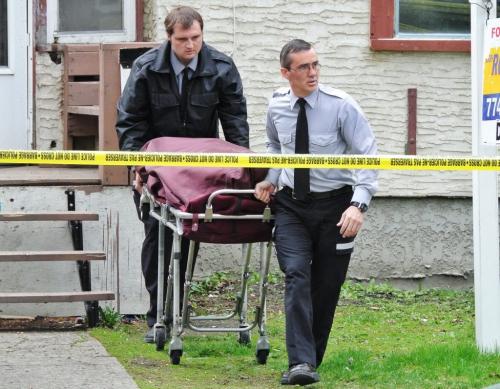 The coroner removes a deceased person from 854 Home Street Tuesday afternoon.  120501 May 01, 2012 Mike Deal / Winnipeg Free Press